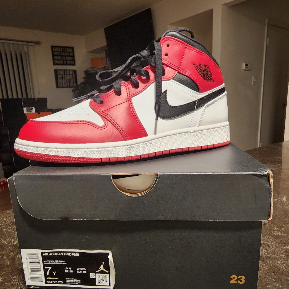 This is a retro 1 jordan black gym red and white gs